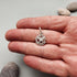 products/anvil-charm-silver-hand.jpg